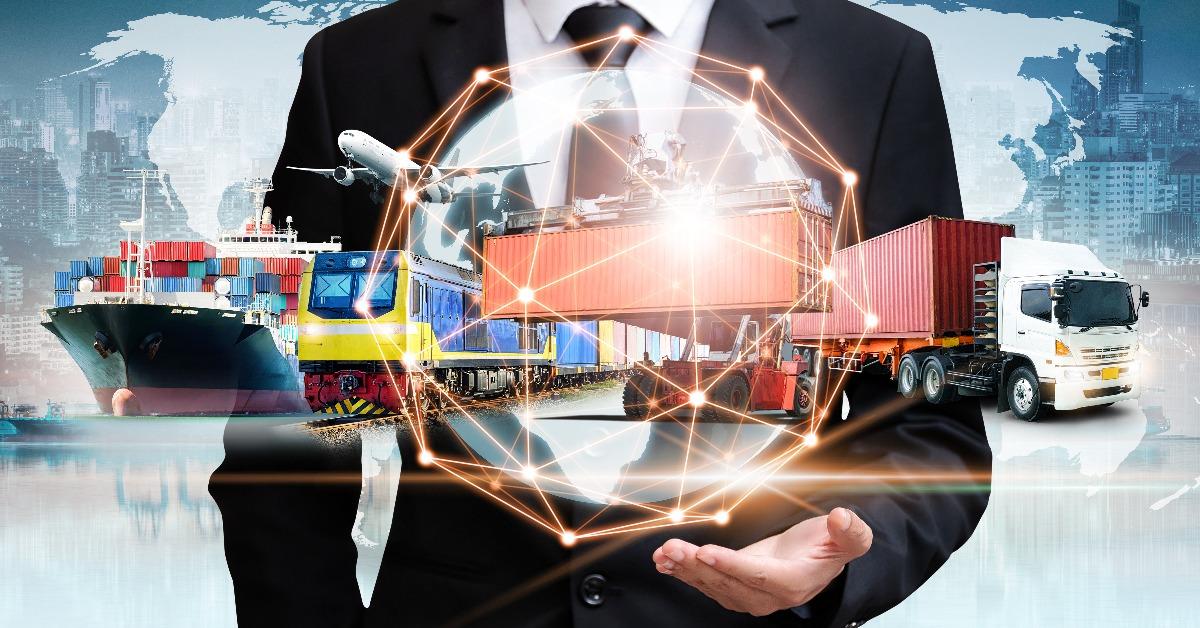 businessman holding digital globe in palm for logistics concept
