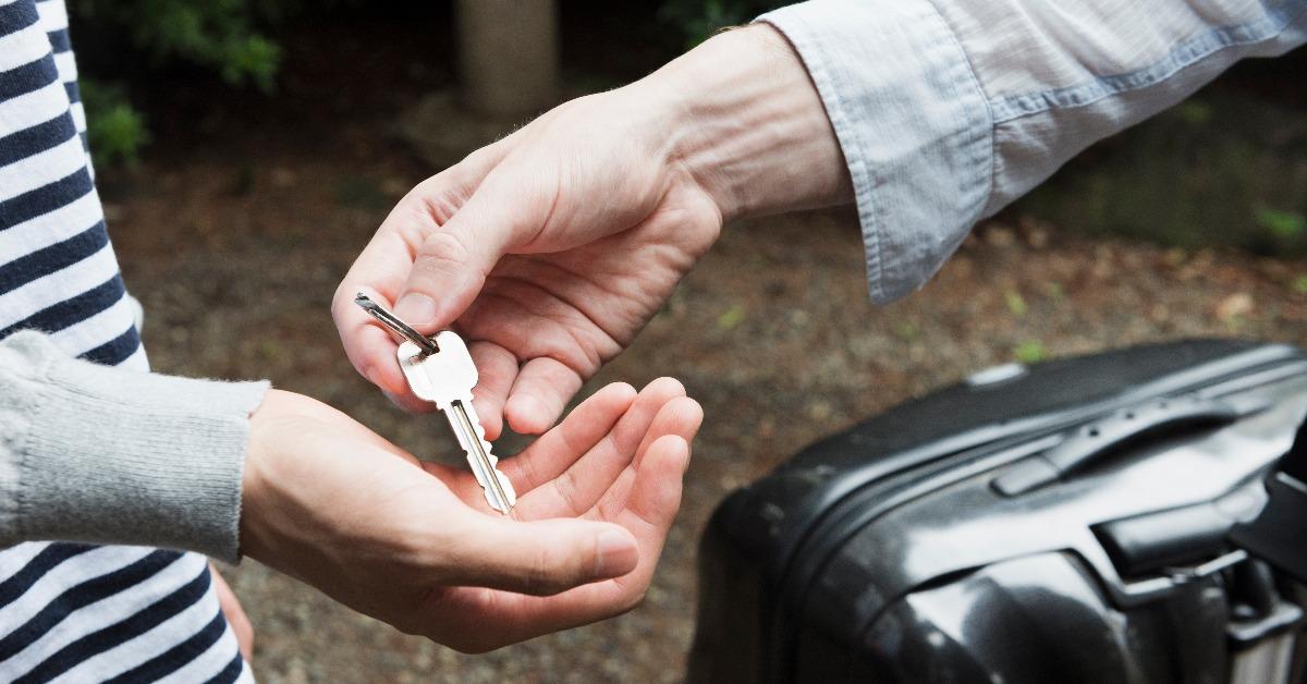hand giving a key