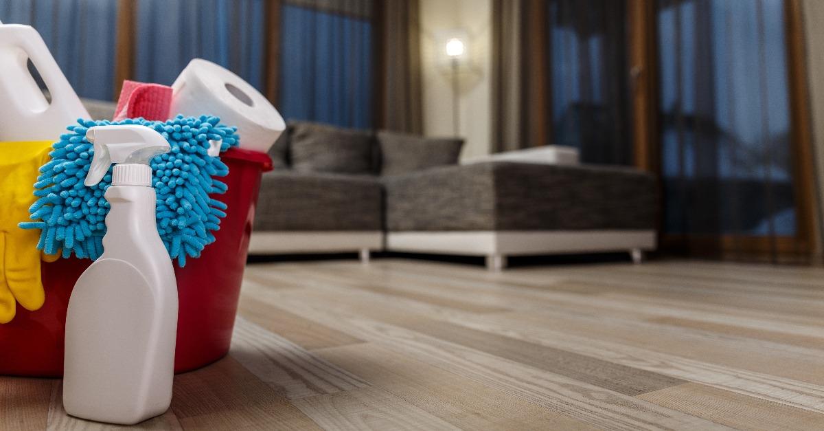 bucket with chemical bottles and rubber gloves