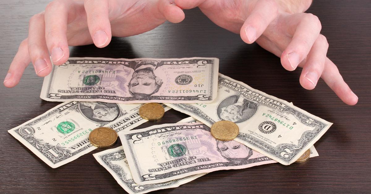 hands and money on the table