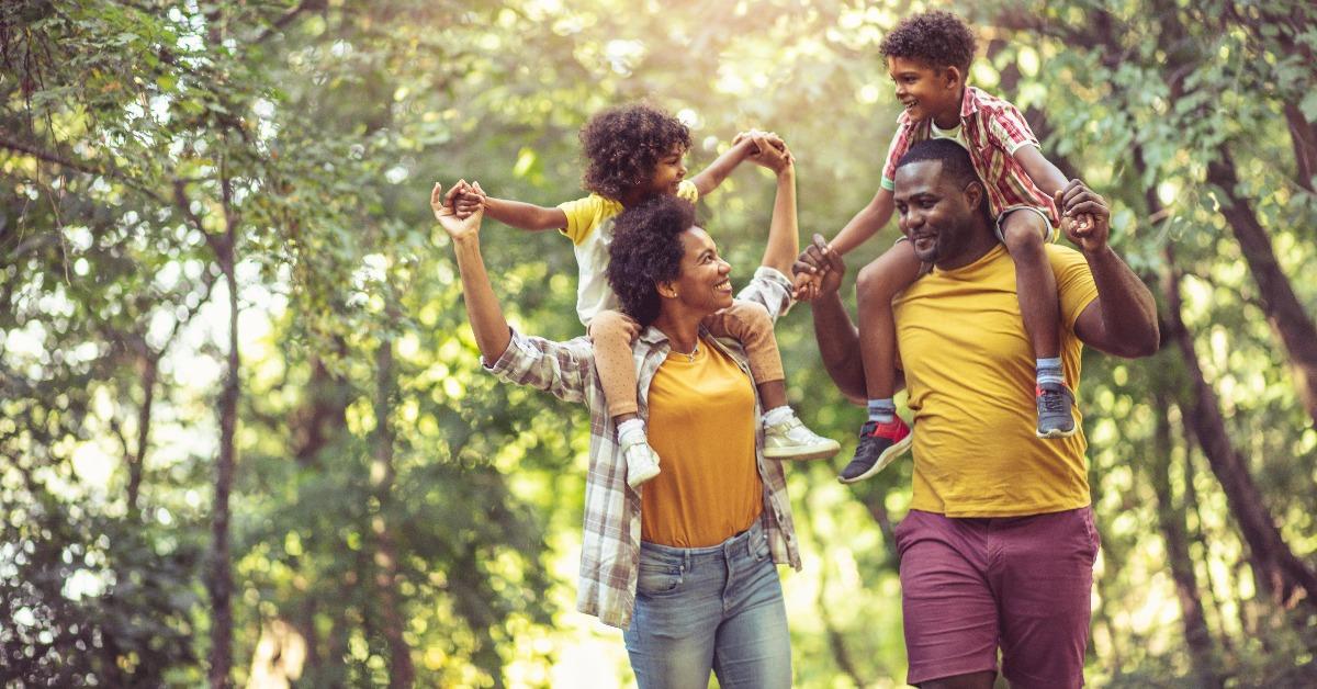 parents carrying children on piggyback