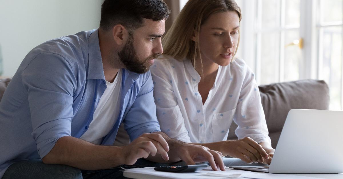 wife showing online domestic payment app to husband checking bills
