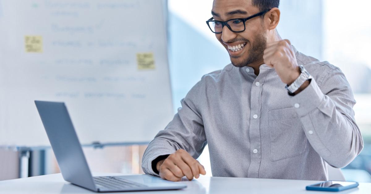 Man on laptop with a smile