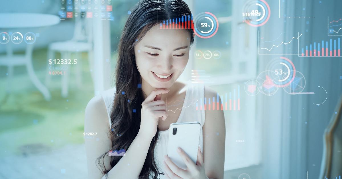 female trader looking at her cellphone