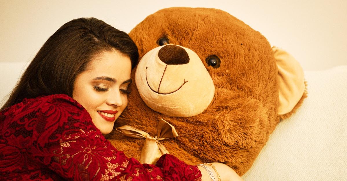 woman hugs big giant bear 