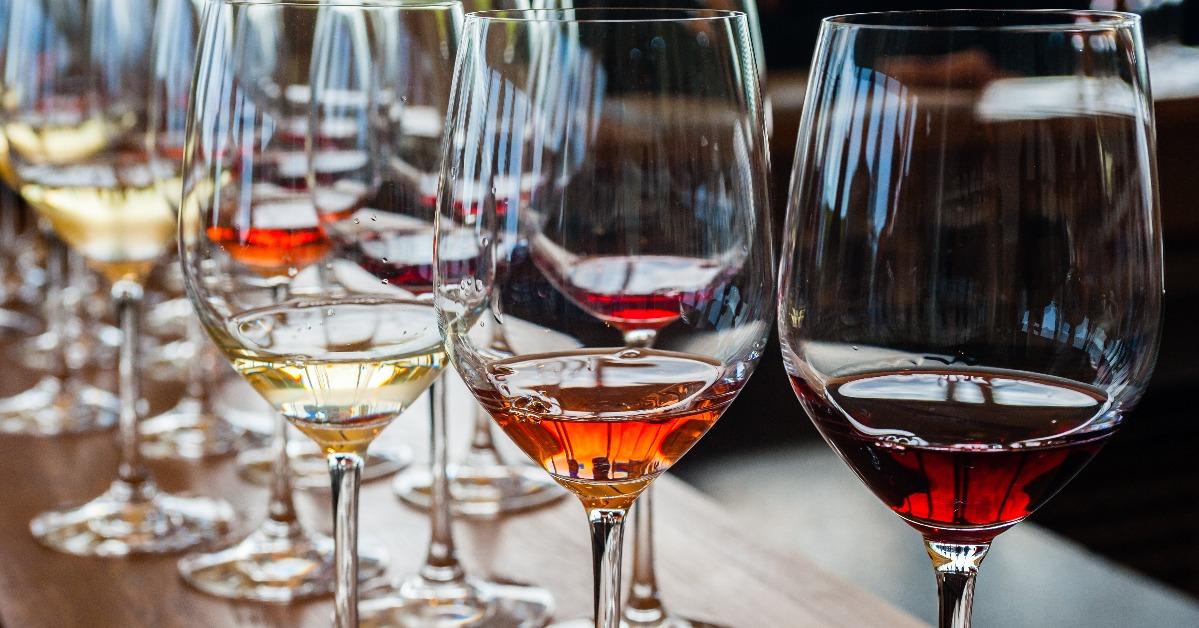 three wine glasses with samples on wood counter