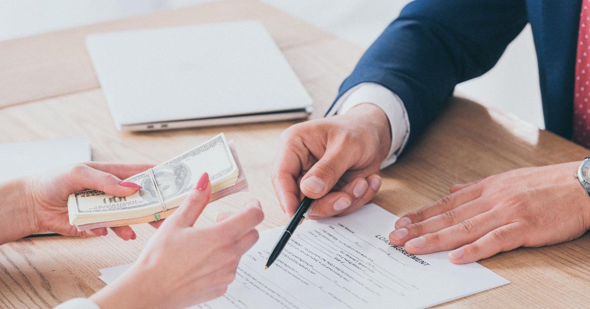 businessman pointing at signature place in loan agreement