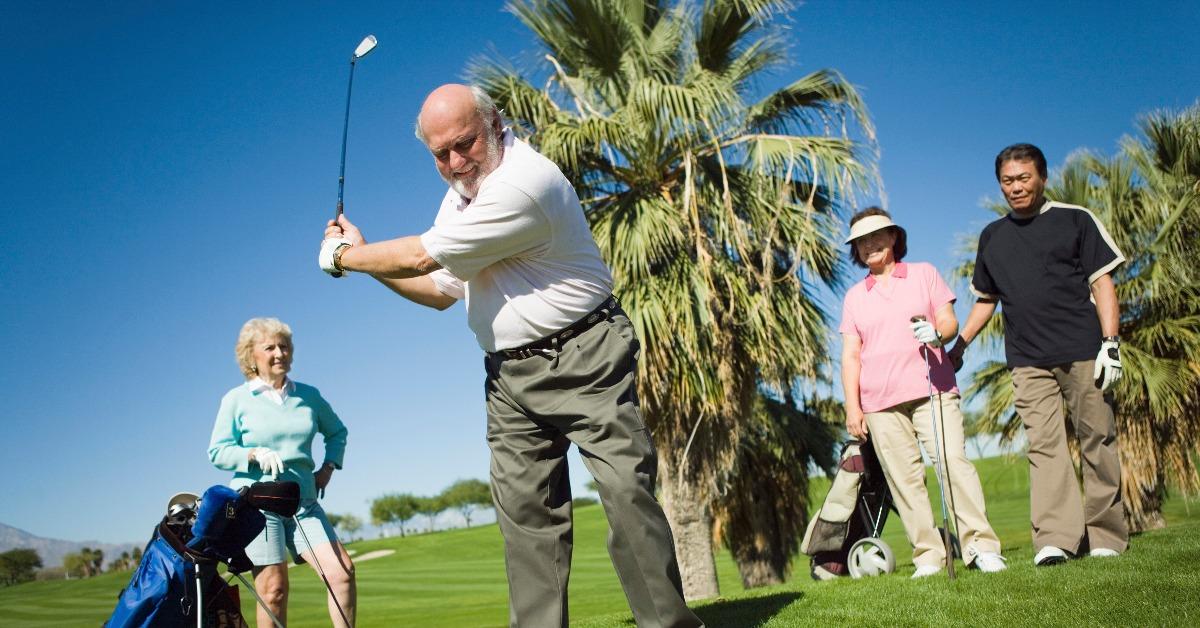 multiethnic friends playing golf at golf course