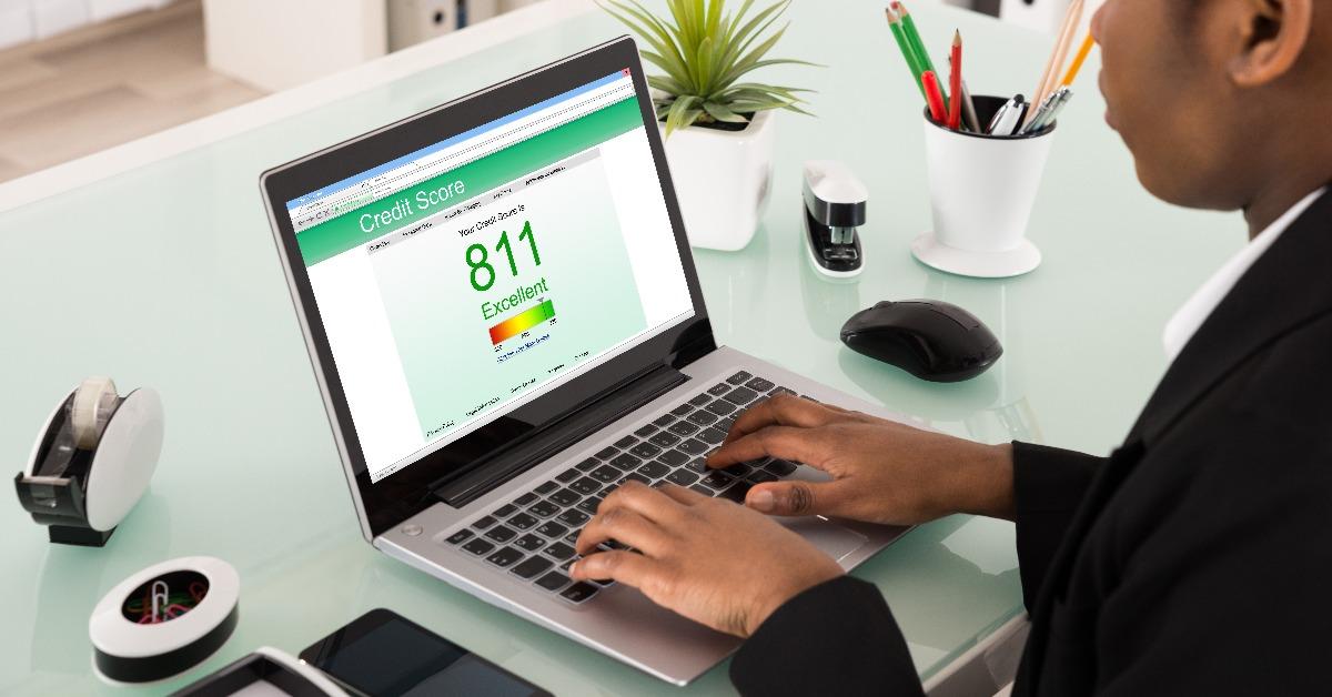 businesswoman checking credit score on laptop
