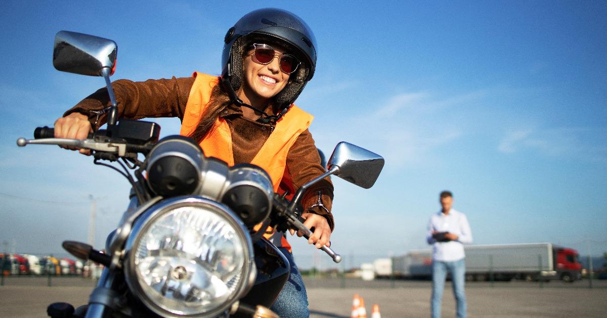 student with helmet taking motorcycle lessons
