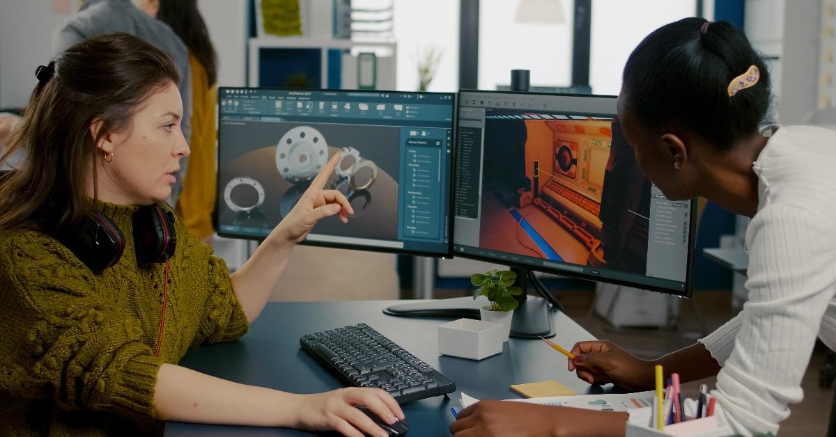 game creator explaining to a workmate how testing game level interface works