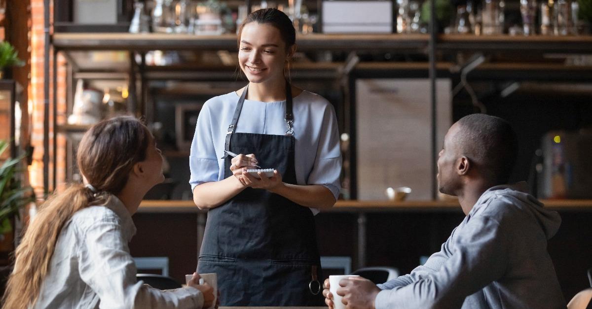 waitress taking order from multiracial clients