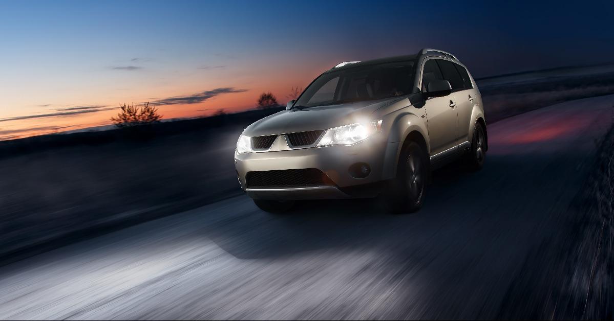 car fast speed drive on asphalt road at dusk