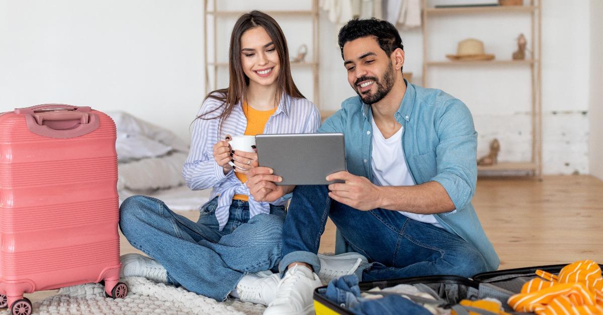tourists couple using digital tablet and booking travel tickets