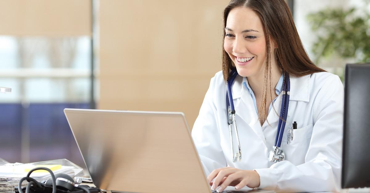happy doctor using a laptop at consultation