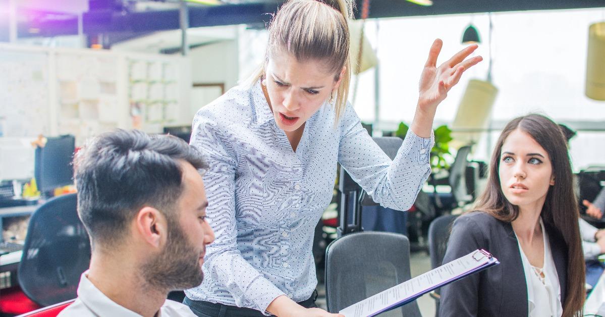 businesswoman shouting to a stressed employee at office