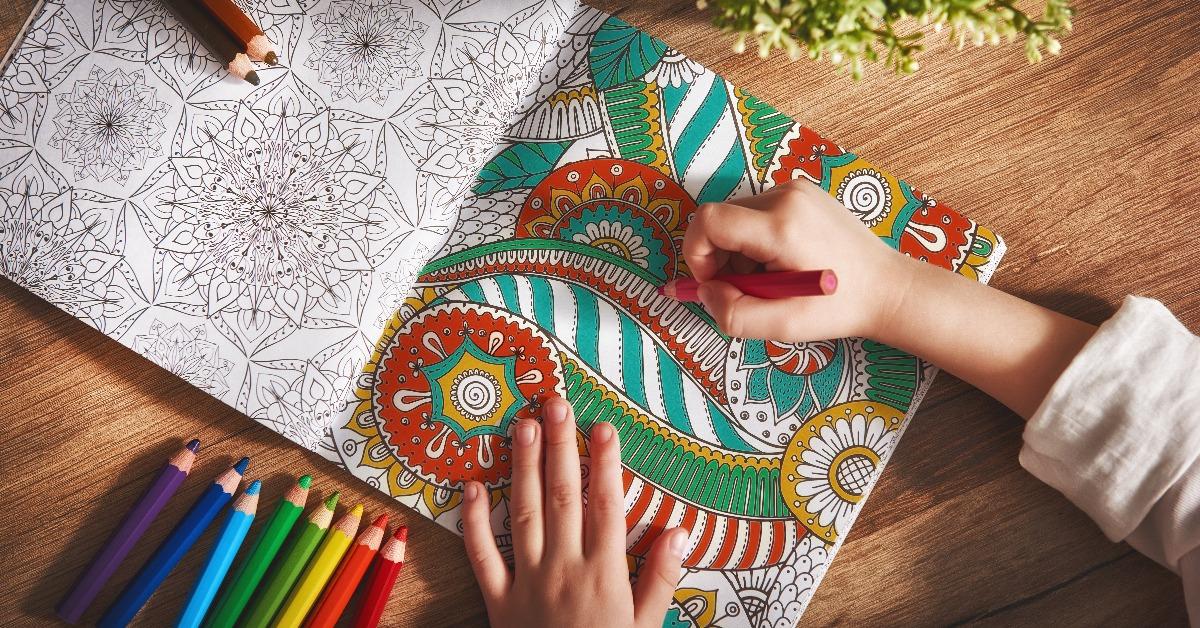 child paints a coloring book