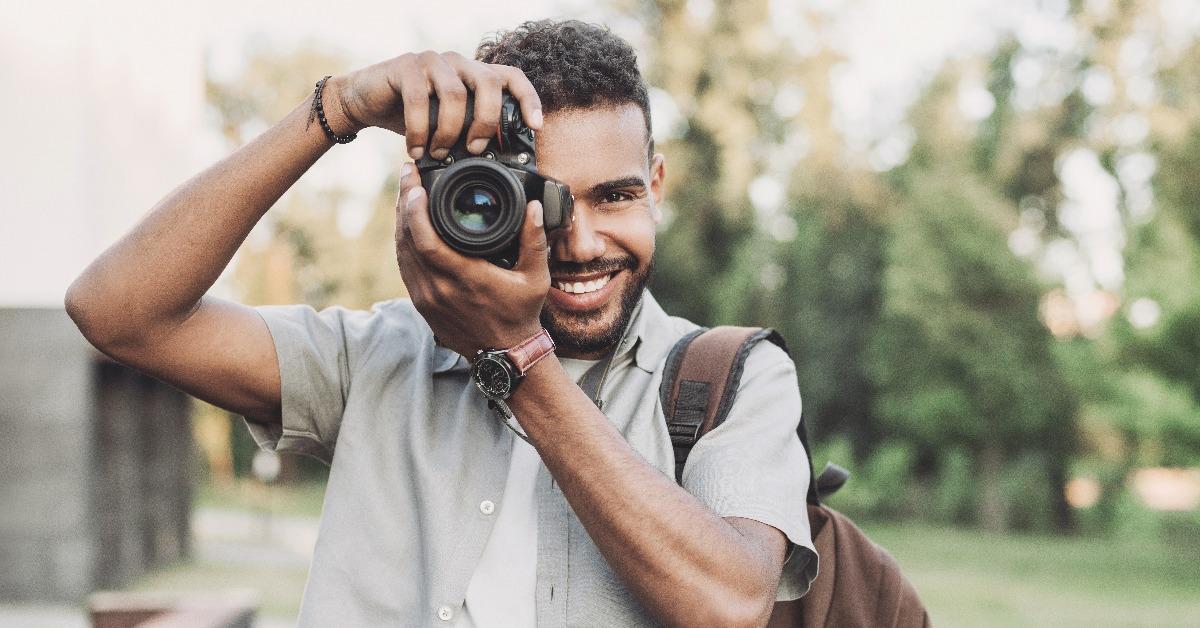 photographer takes photographs with dslr camera in a city
