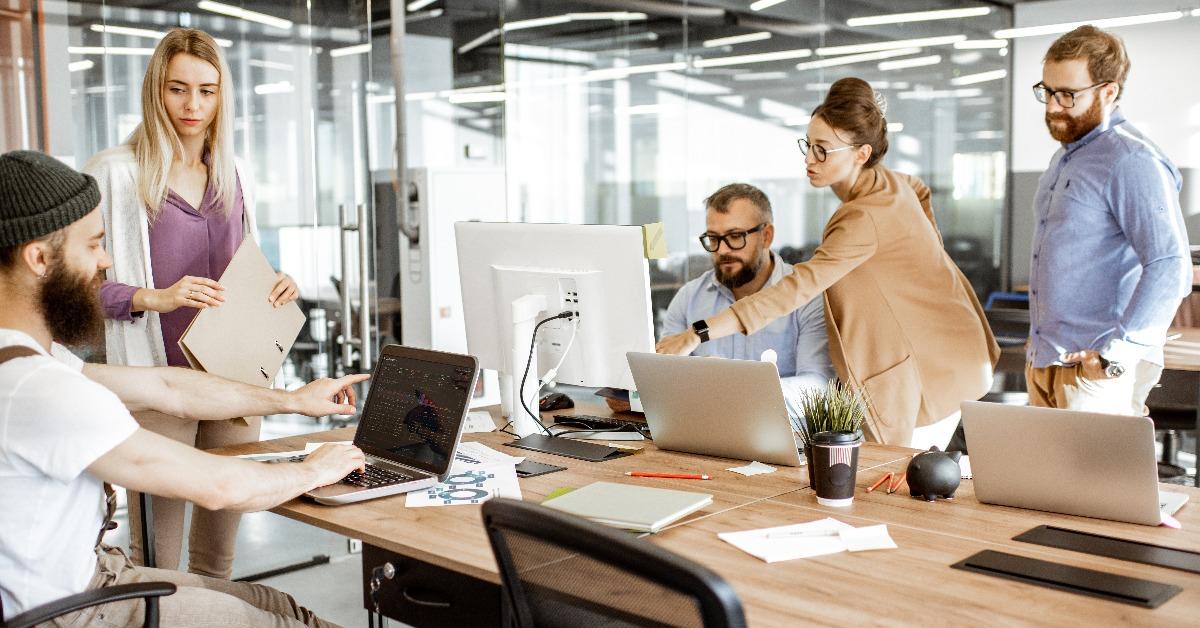 colleagues working on the computers in the modern office or coworking space