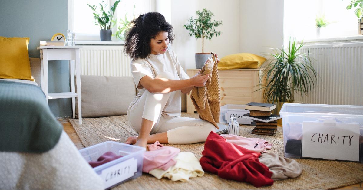 woman sorting wardrobe indoors at home