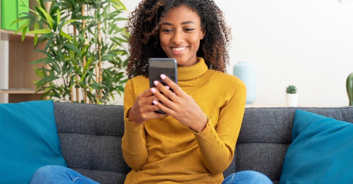 woman scrolling on smartphone at home
