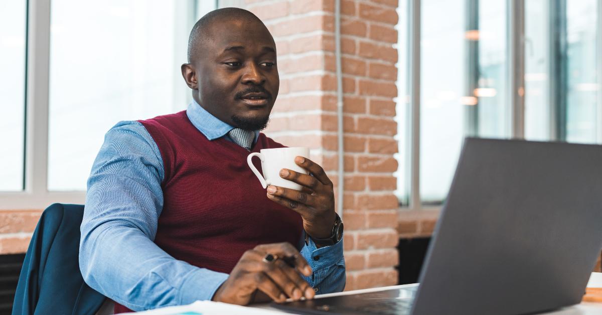 man in a business suit working on a laptop