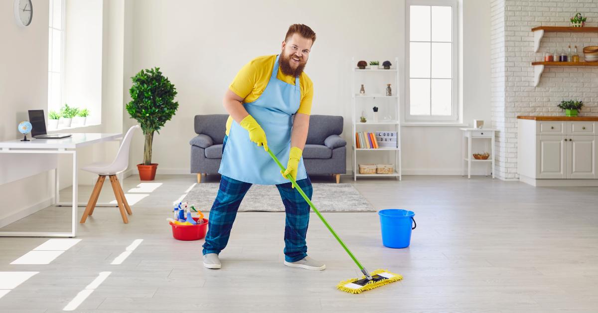 man in an apron and yellow cleaning gloves