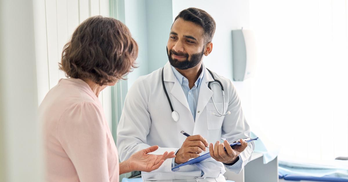  doctor consulting senior old patient filling form 