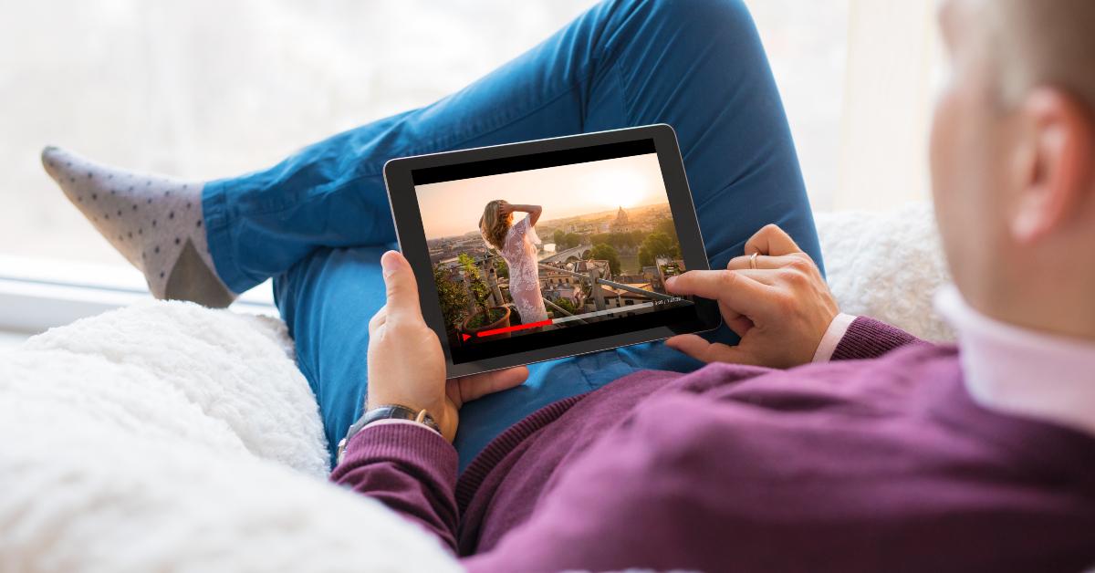 man watching movie on tablet at home