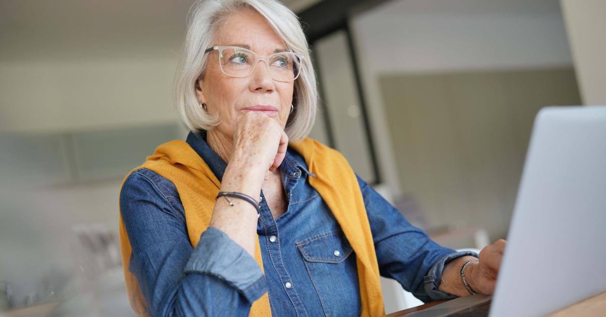 senior woman working on laptop in modern home