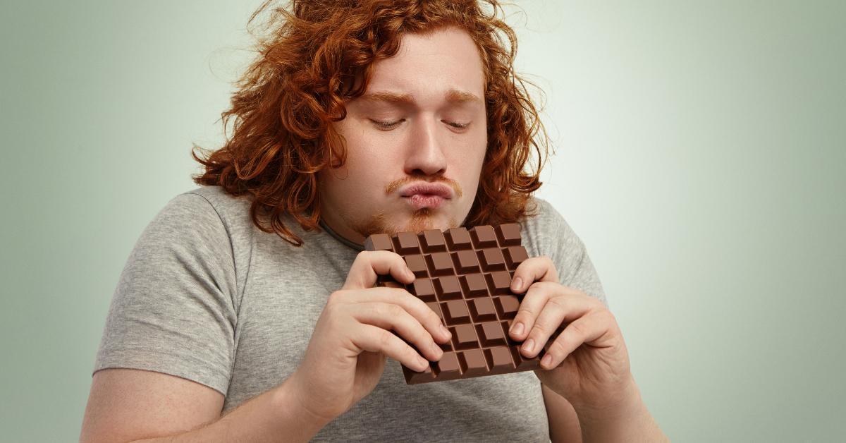 holding large bar of chocolate with both hands