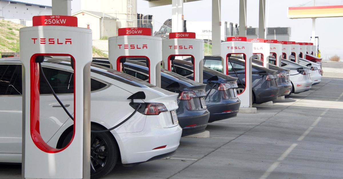 cars charging at a Tesla Supercharger station