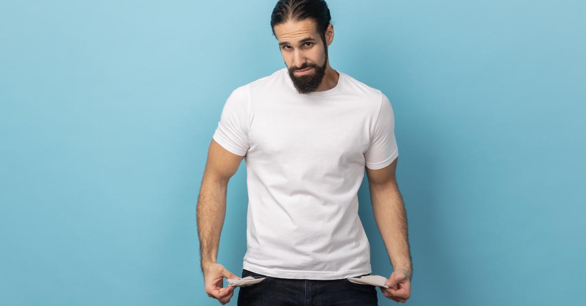 man with beard wearing white T-shirt showing empty pockets