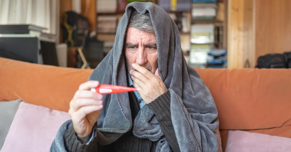 sick man surprised by the high temperature of the thermometer