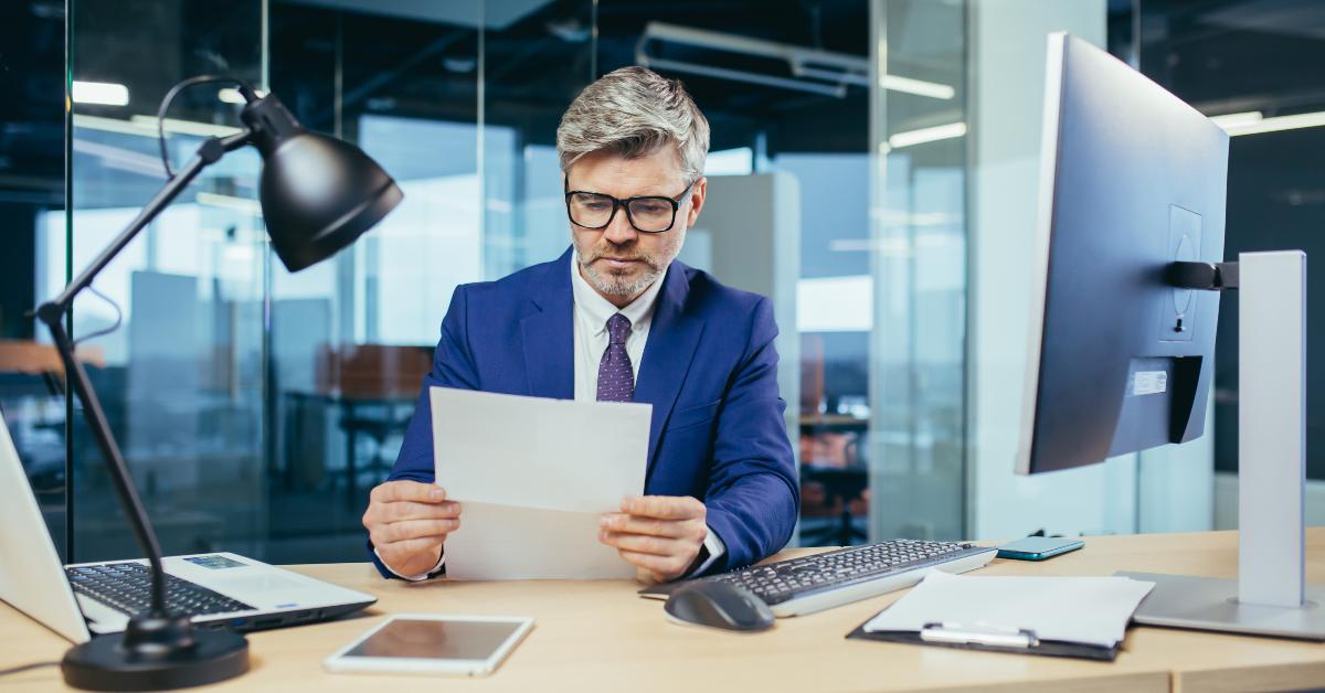 gray-haired businessman working at a computer