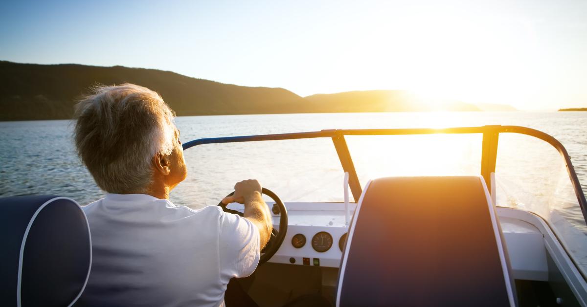 mature man driving speedboat