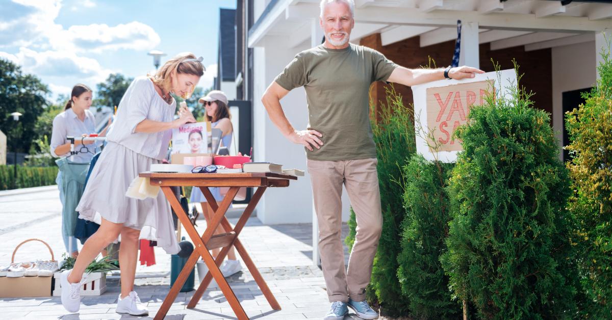 mature man organizing yard sale