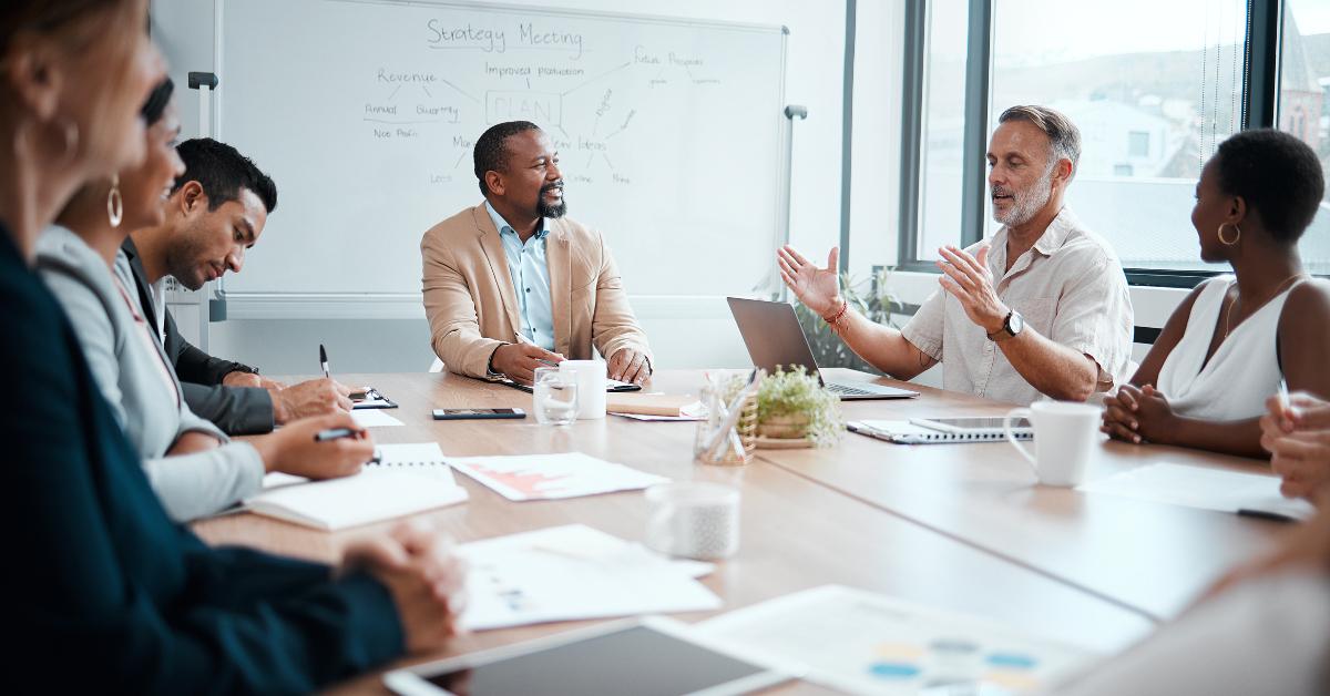 staff listening to their boss during a business meeting