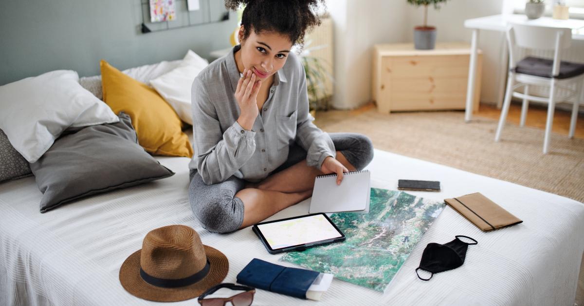 woman with tablet and map indoors at home