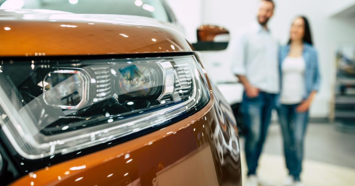 couple buying a new car in dealership