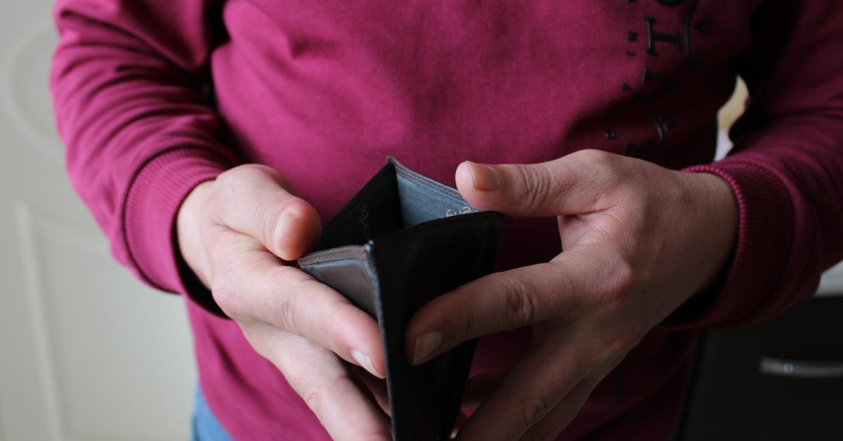 man hands holding an open empty wallet