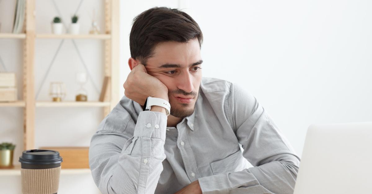 tired man in his office working on laptop