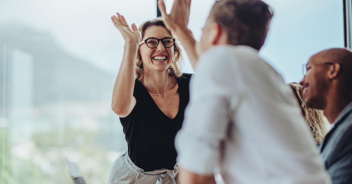 businesswoman giving a high five to a colleague
