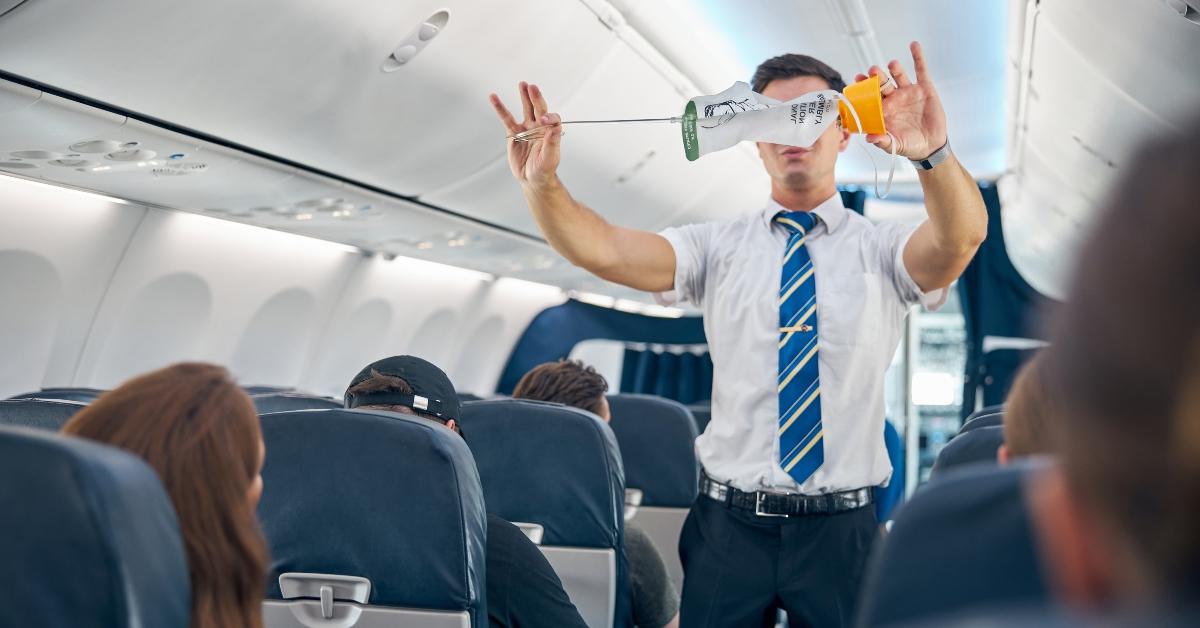 steward demonstrating safety procedure