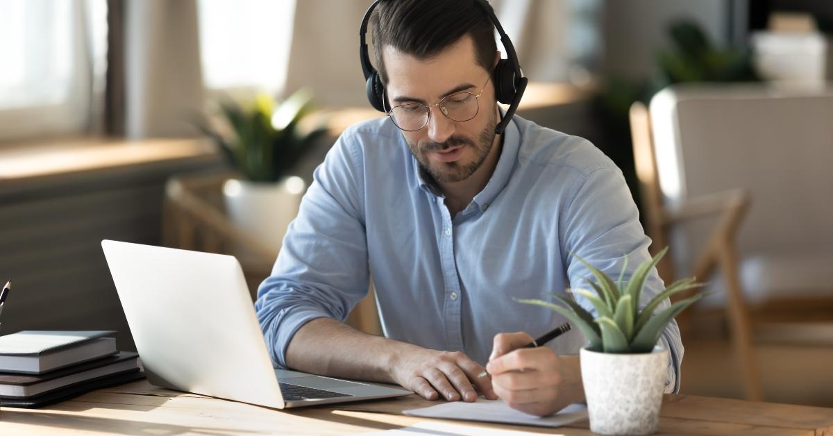businessman in eyeglasses wearing wireless headset with microphone