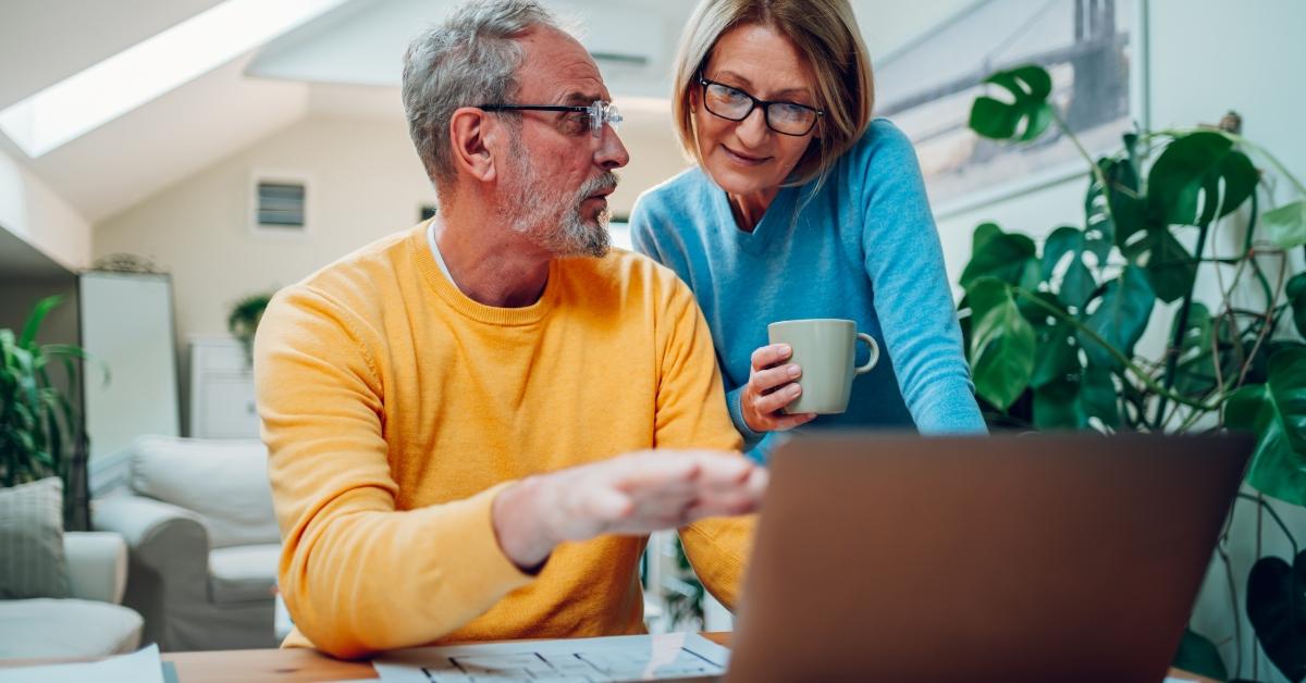 senior happy couple using laptop