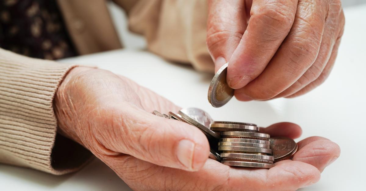 Elderly person counting coins