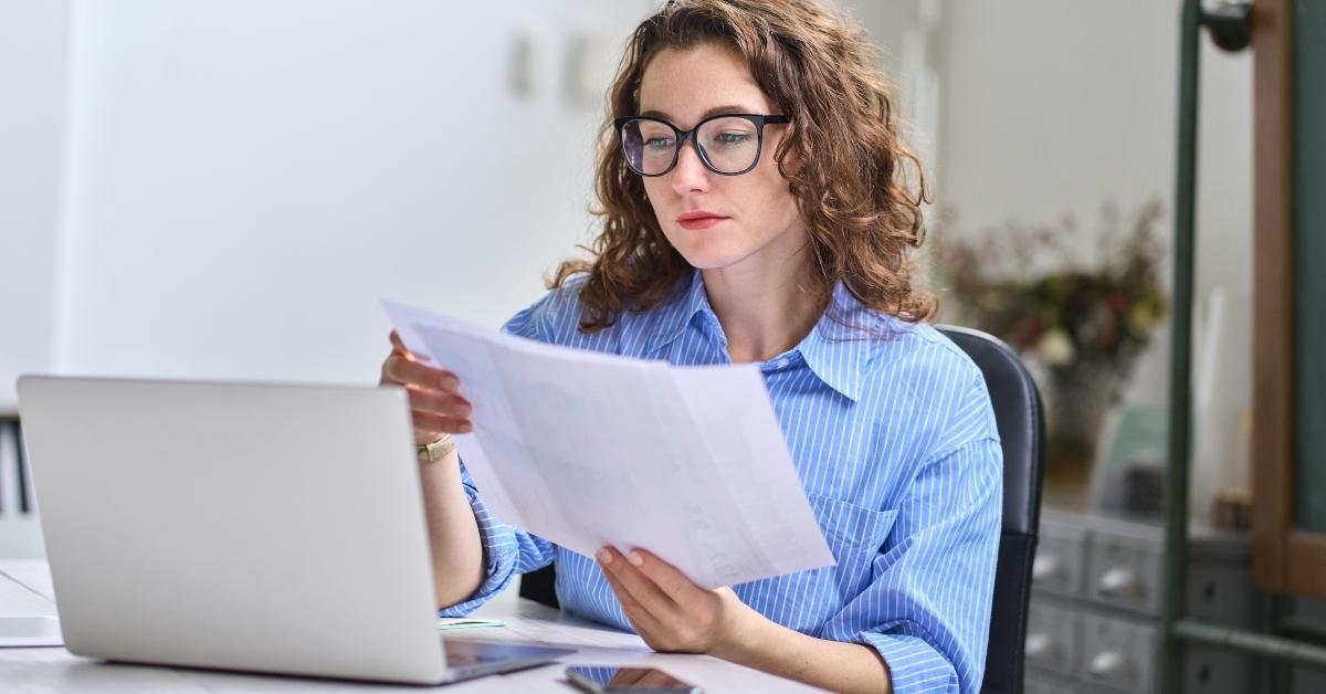 female employee holding bookkeeping documents