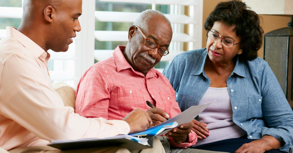 financial advisor talking to senior couple at home
