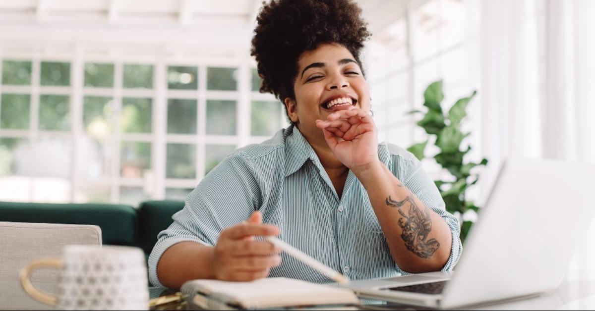 cheerful woman sitting at home office desk